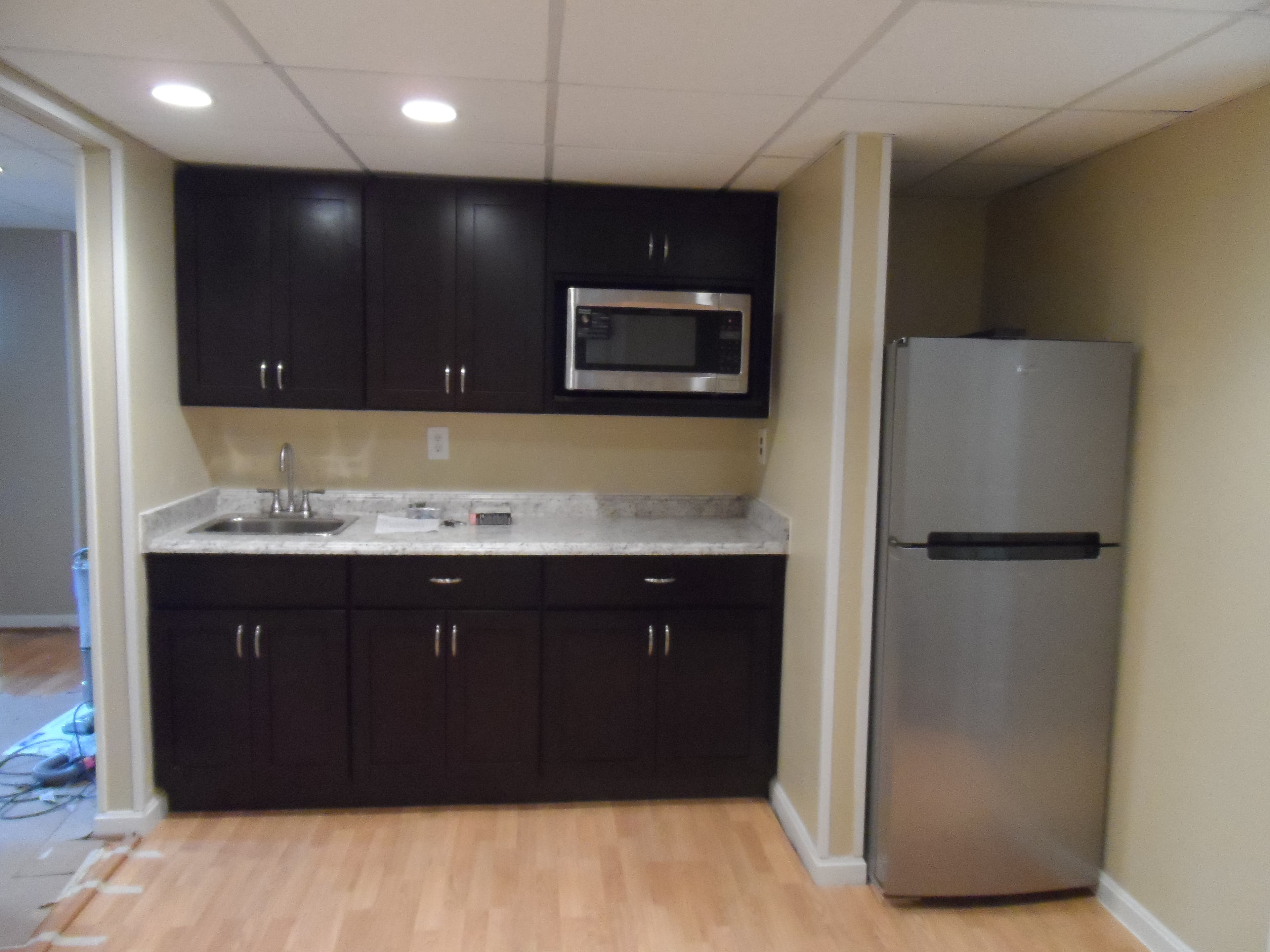 Basement room with kitchen after image 6