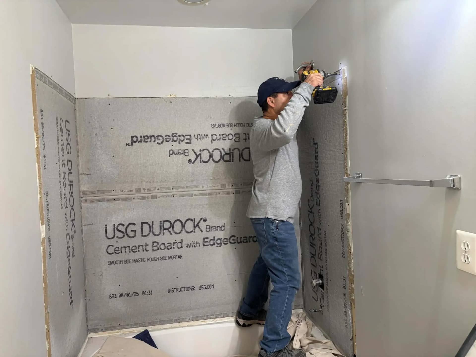 Melvin installing cement backer board for a shower remodeling project