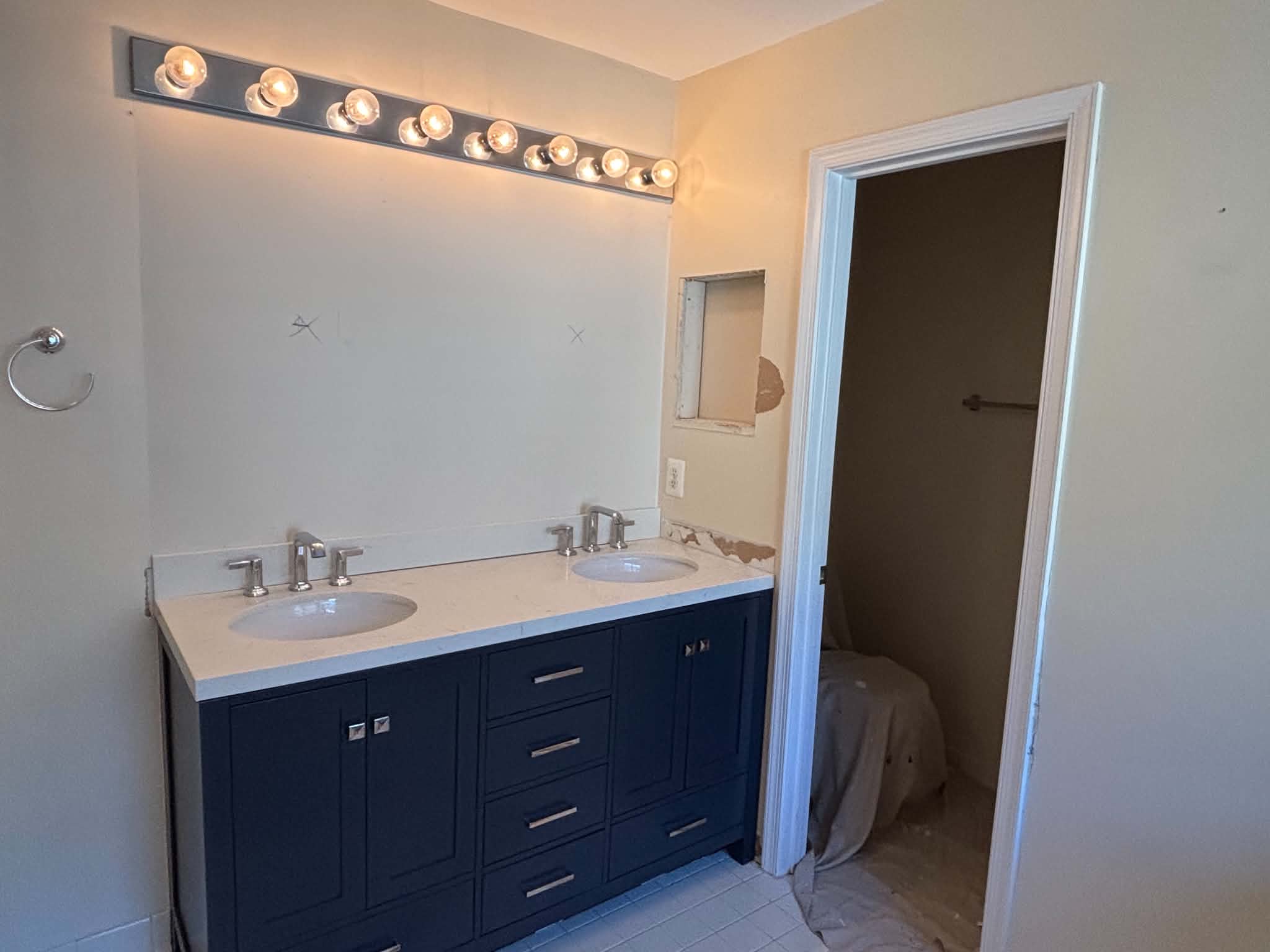Wall removal and vanity upgrade before image 1